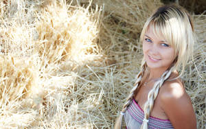 Blonde Woman On A Bed Of Hay Wallpaper