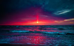 Blue And Purple Sunset With A Red Sun Wallpaper