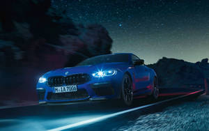 Blue Bmw Driving At Night Wallpaper