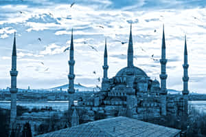 Blue Mosque With Birds Flying Wallpaper