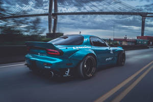 Blue Sports Car Cloudy Sky Wallpaper