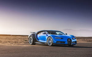 Blue Sports Car Desert Road Wallpaper