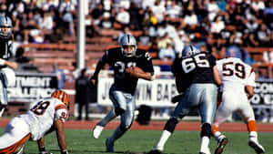 Bo Jackson With An Opponent Tripping Wallpaper