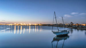 Boat Against City View Wallpaper