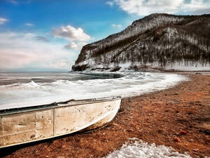 Boat Near The Crashing Waves Wallpaper