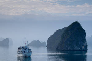 Boat On Misty Island Wallpaper