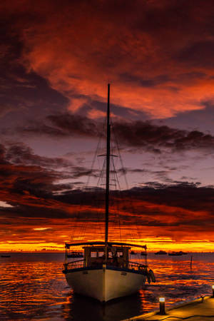 Boat On Sea During Sunset Wallpaper