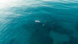 Boat On Vast Ocean Blue Waters Wallpaper