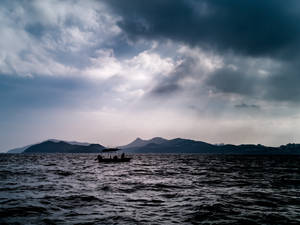 Boat Silhouette On Black Ocean Wallpaper