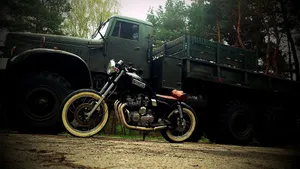 Bobber Motorcycle By An Army Truck Wallpaper