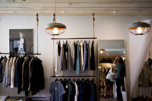 Boutique Clothes On Wire Racks Mirror Wallpaper