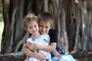 Boy Hugging Sister Wallpaper
