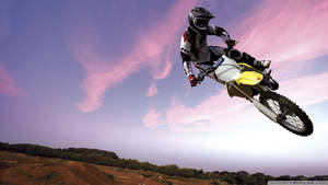 Breathtaking Mid-air Moment On A Dirt Bike Wallpaper