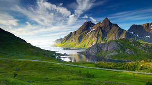 Breathtaking Panoramic View Of A Green Mountain Wallpaper