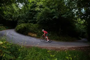 Breathtaking Uphill Mountain Cycling Wallpaper