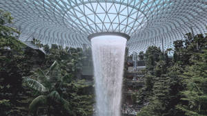 Breathtaking View Of Falling Water At Jewel Changi Airport Wallpaper