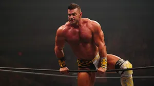 Brian Cage Exhibiting Power In The Wrestling Ring Wallpaper