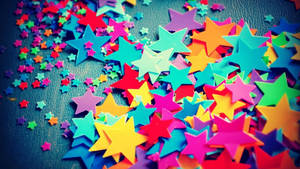 Brighten Your Day With These Cheerful Colorful Confetti Stars! Wallpaper