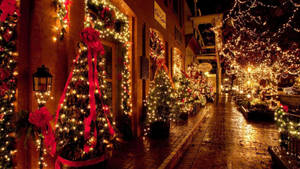 Brightly Lit Alley In Festive Christmas Lights Wallpaper