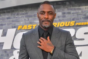 British Actor Idris Elba Stylishly Adjusting His Tie Wallpaper