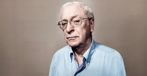 British Actor Michael Caine In Blue Shirt Portrait Wallpaper