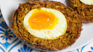 British Scotch Egg Dish With Runny Yolk Center Wallpaper