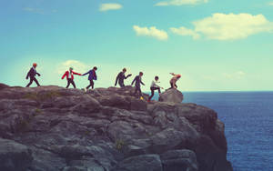 Bts Group Photo At Rock Mountain Wallpaper