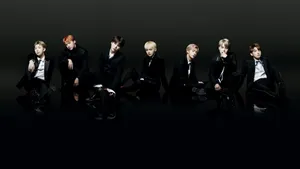 Bts Members In Black On Black Floor Laptop Wallpaper