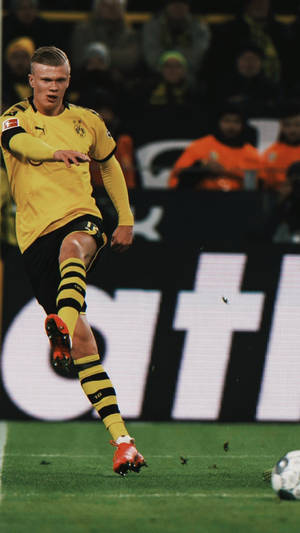 Bvb Player Erling Haaland Kicks The Ball Wallpaper