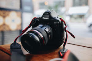 Canon Photography Camera On Wooden Table Wallpaper