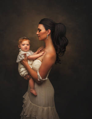 Caption: A Precious Moment Between Mother And Baby In A Luxurious Studio Shoot. Wallpaper