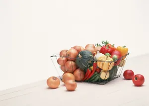 Caption: An Enlivened Basket Of Fresh Vegetables Wallpaper