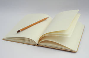 Caption: Blank Journal With Pencil Ready For Idea Generation Wallpaper