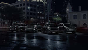 Caption: Bold Stance Of Black Tundra Trucks Against The Majestic Backdrop Wallpaper