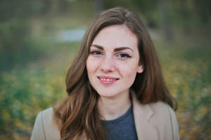 Caption: Confident Corporate Woman: A Headshot Wallpaper