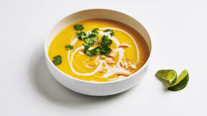 Caption: Delicious Pumpkin Soup With Cream Garnish Wallpaper