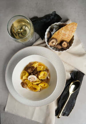 Caption: Delicious Tortellini In Brodo With Mushrooms Wallpaper
