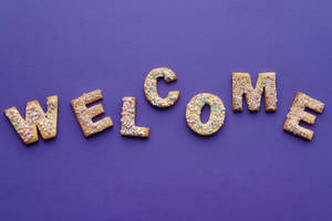 Caption: Delightful Welcome Cookies In Letter Shapes Wallpaper