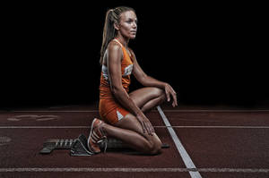 Caption: Determined Fit Woman At Race Track Starting Point. Wallpaper