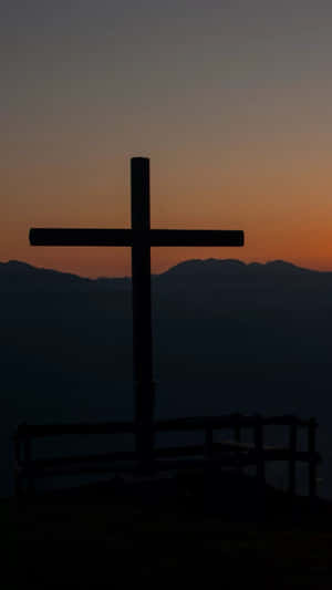 Caption: Divine Sanctity - A Gleaming Cross On Iphone. Wallpaper