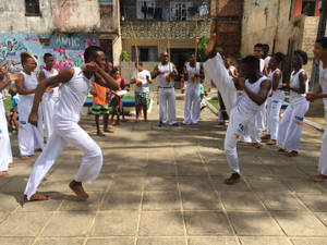 Caption: Dynamic Capoeira Street Sparring Dancing To Rhythm Wallpaper