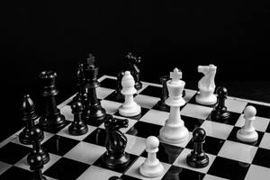 Caption: Engaging Mind Games: Black And White Plastic Chess Pieces On The Board Wallpaper