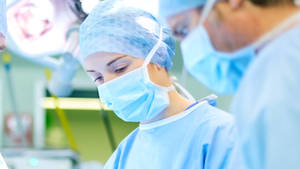 Caption: Expert Surgeons In Action Wallpaper