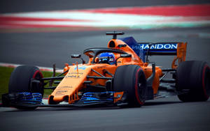 Caption: Fernando Alonso Racing In Orange Mclaren Wallpaper