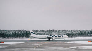 Caption: Finnair Aircraft Ready For Departure On Tarmac Wallpaper