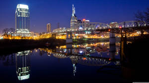 Caption: Glistening Night Skyline Of Jersey City, New Jersey Wallpaper