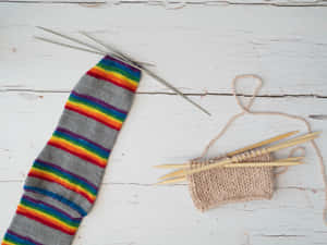 Caption: Handcrafted Knitted Sock On The Needle Wallpaper