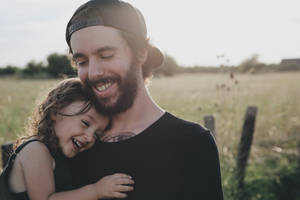 Caption: Heartwarming Moment Between Father And Son Wallpaper