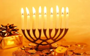 Caption: Illuminating Hanukkah Celebration With Traditional Coins And Candles Wallpaper