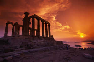 Caption: Magnificent Sunset Over Poseidon's Temple In Sounion Wallpaper